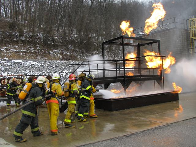 Hose lines approach the flange/pan fire